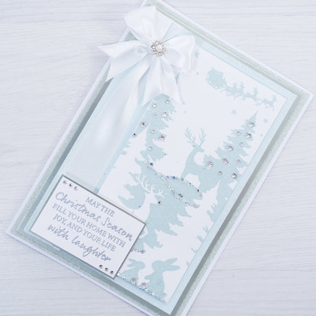 Learn how to make your own Christmas cards at home by following this free step-by-step tutorial from Chloes Creative Cards showing you how to make this icy blue and white reindeer winter wonderland scene.