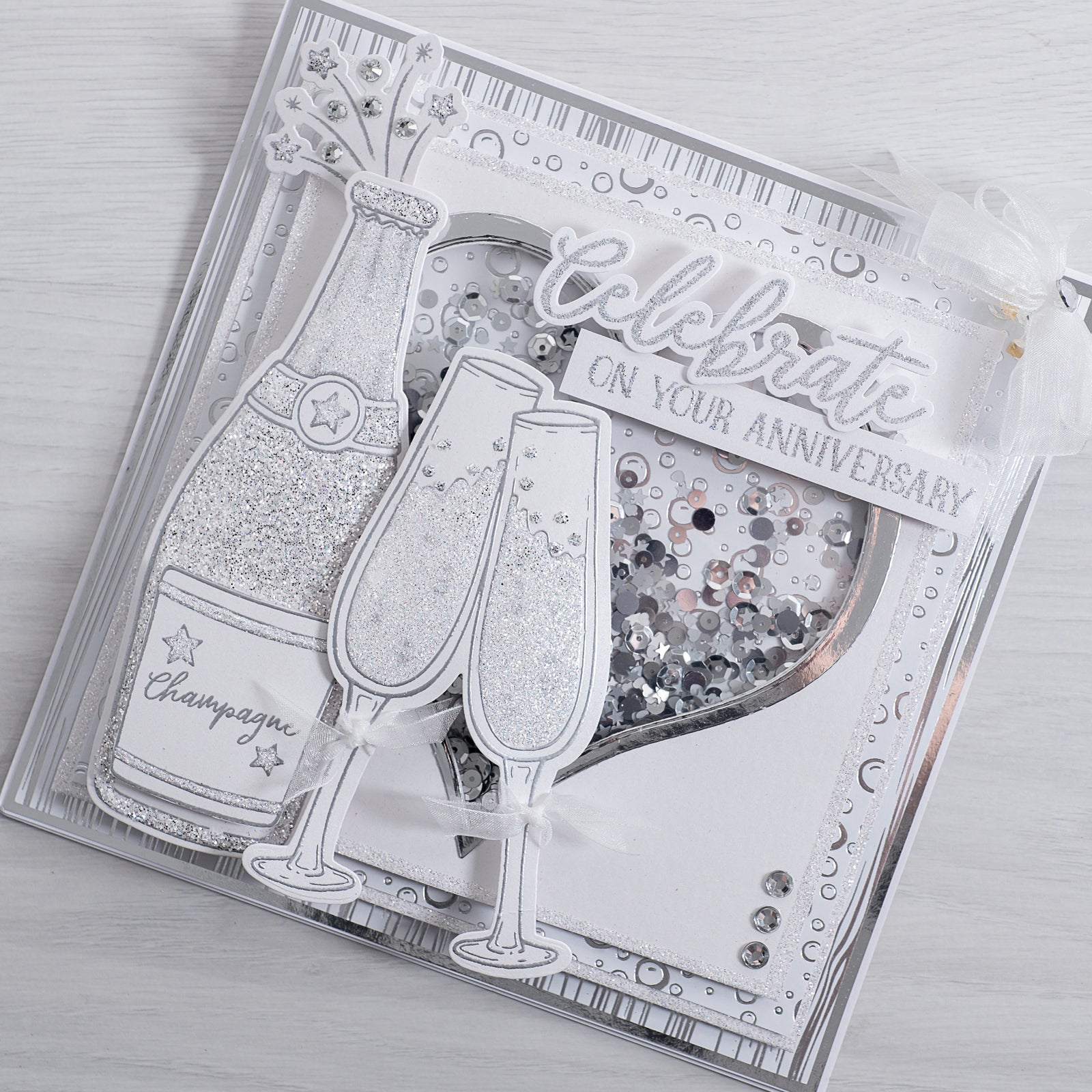 Learn how to create this sparkling champagne bottle anniversary card using our new celebrate sentiment builder stamp and champagne glasses stamp from Chloes creative cards