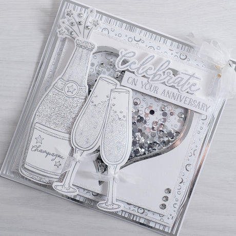 Learn how to create this sparkling champagne bottle anniversary card using our new celebrate sentiment builder stamp and champagne glasses stamp from Chloes creative cards